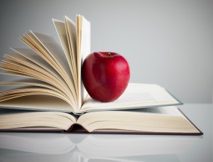 red apple on books